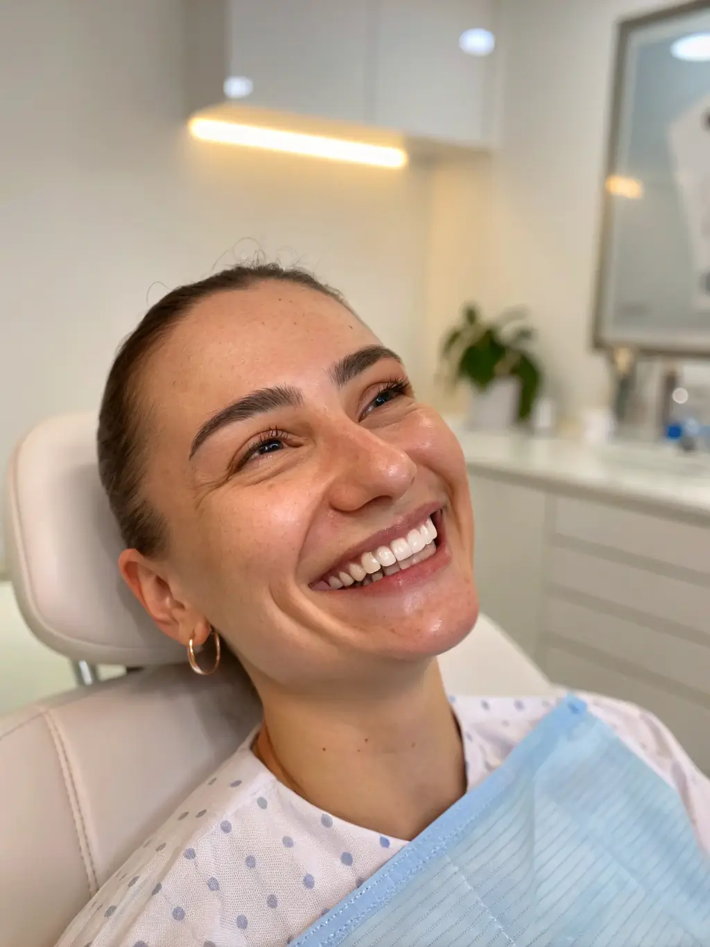 A happy patient smiling after receiving earwax removal treatment at The Listening Lounge, emphasizing the positive experience and improved hearing.